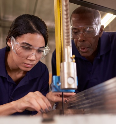 Man and Woman Working with Manufacturing Equipment