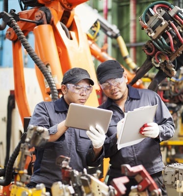 Two Men with Clipboards in Manufacturing Plant