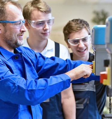 Volunteer Teaching Students about Manufacturing Equipment